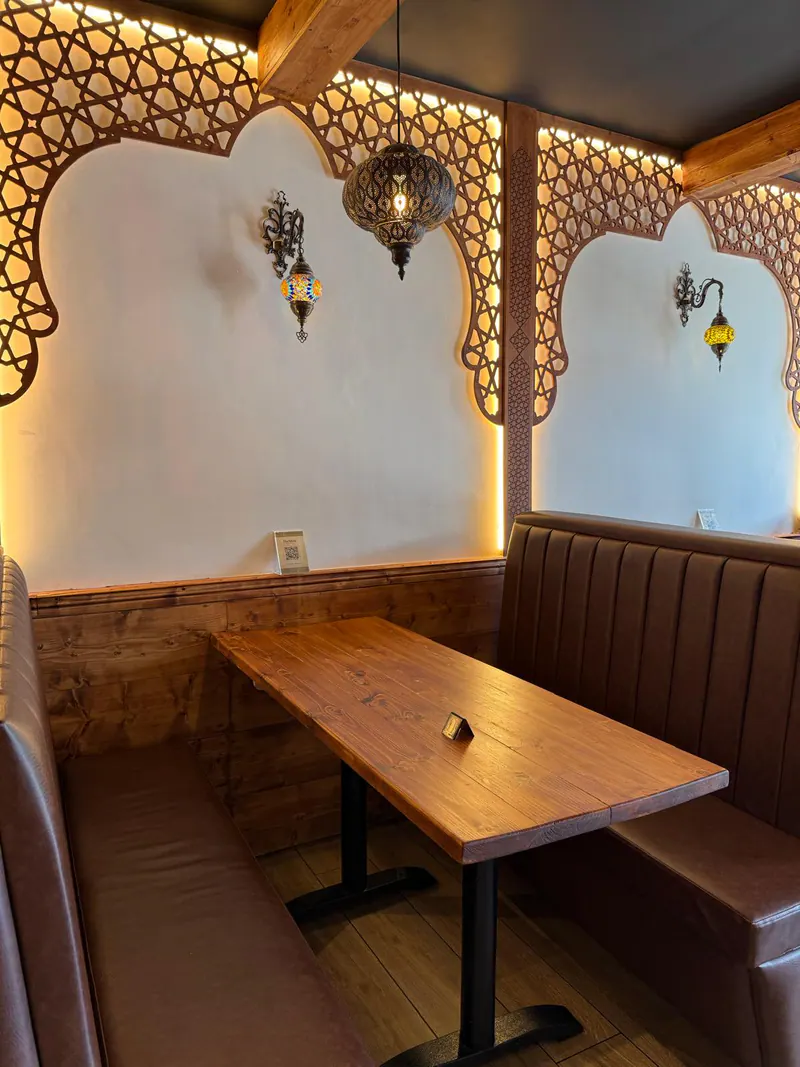 A booth beneath the carved arches